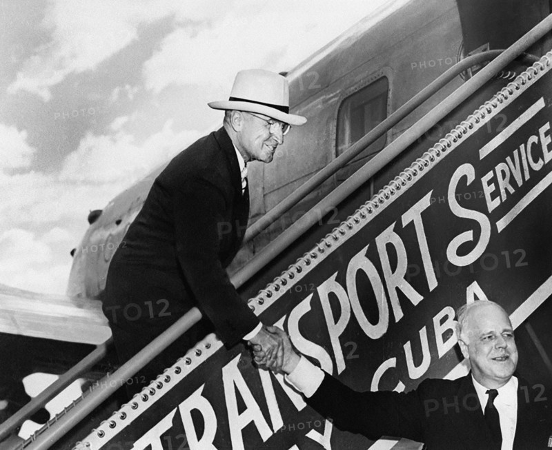 U.S. President Harry S. Truman shaking hands with White House doorkeeper William Simmons as he descends the airplane stairs upon his return from his Florida vacation, Washington National Airport, Washington, D. C., USA, Abbie Rowe, National Parks Service, Harry S. Truman Library, March 5, 1948