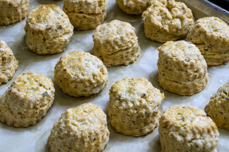 Close-up view baking sheet filled with savory scones