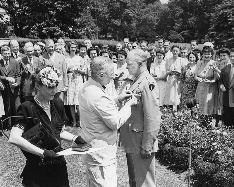 U.S. President Harry S. Truman (center) pinning Distinguished Service Medal on U.S. General Dwight D. Eisenhower while the General's wife Mamie Eisenhower (left) looks on, Washington, D.C., USA, Abbie Rowe, National Parks Service, Harry S. Truman Library, June 18, 1945