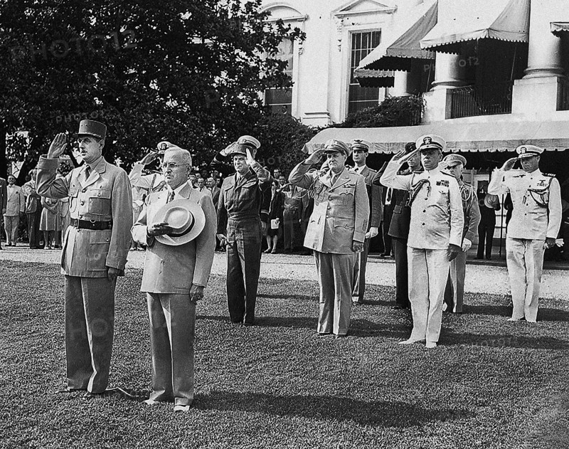 U.S. President Harry S. Truman, right, and Charles De Gaulle, Chairman of the Provisional Government of the French Republic, left, stand at attention during the welcoming ceremonies for the French visit to the White House, Washington, D.C., USA, Abbie Rowe, National Parks Service, Harry S. Truman Library, August 22, 1945