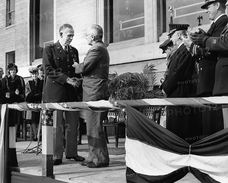 U.S. President Harry S. Truman (right center) shaking hands with retiring U.S. Army Chief of Staff General George C. Marshall (left center) and presenting him with an Oak Leaf Cluster to his Distinguished Service Medal in the Pentagon Court, Arlington, Virginia, USA, Abbie Rowe, National Parks Service, Harry S. Truman Library, November 26, 1945