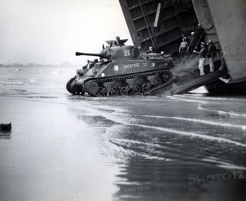 Sherman tanks, manned by French armored troops, rolling down landing ship ramp onto Utah beach, Normandy, France, U.S. Army Signal Corps, August 2, 1944