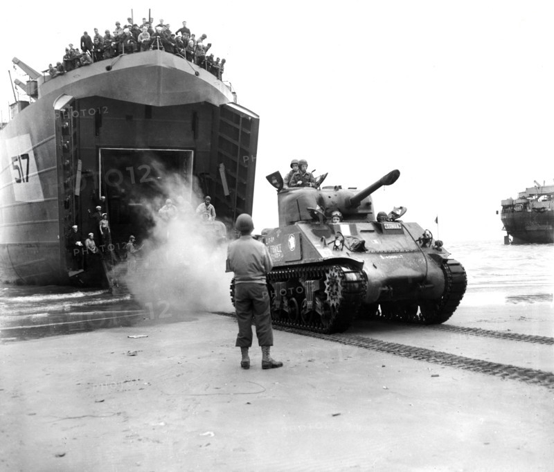 Sherman tanks, manned by French armored troops, rolling out from landing ship ramp onto Utah beach, Normandy, France, U.S. Army Signal Corps, August 2, 1944