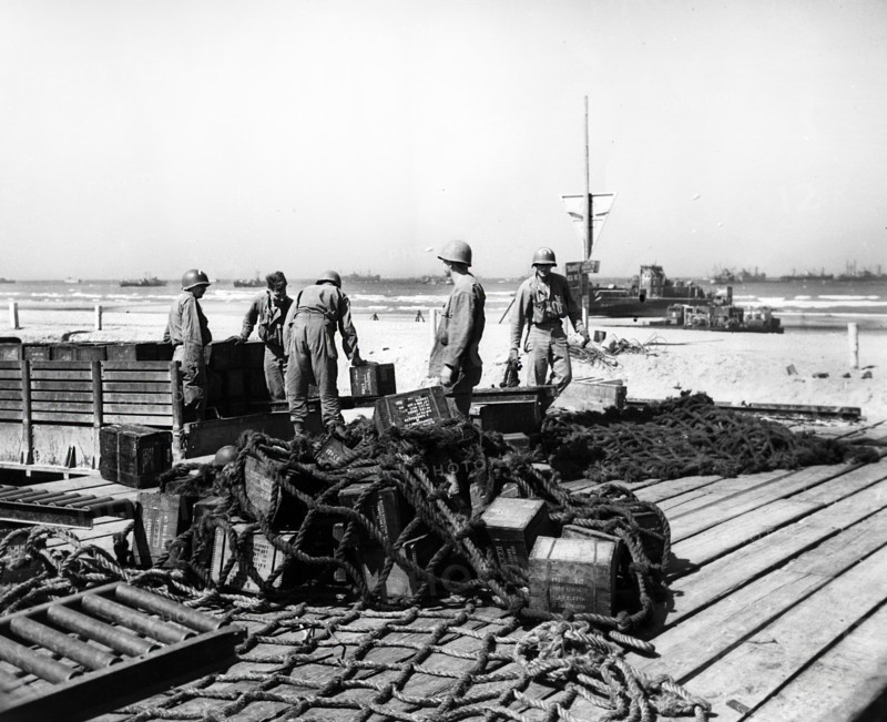 American soldiers loading truck with ammunition to be taken to Carentan, France, and will be transported from there by rail to the front lines, Omaha Beach, Normandy, France, U.S. Army Signal Corps, August 15, 1944