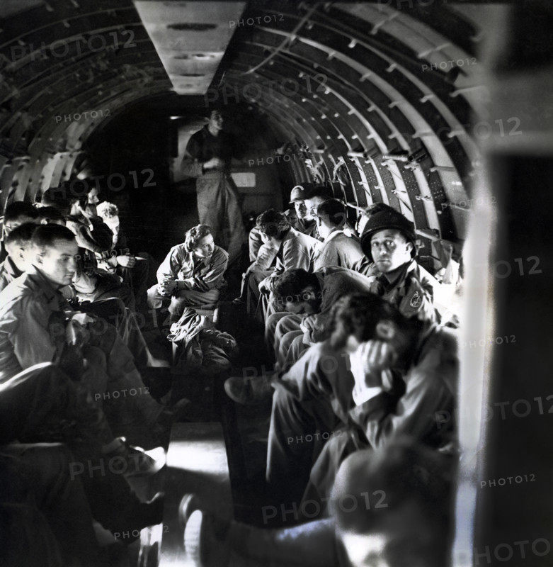 Nurse with wounded American soldiers on C-47 airplane crossing English Channel from Normandy, France, U.S. Army Signal Corps, June 1944