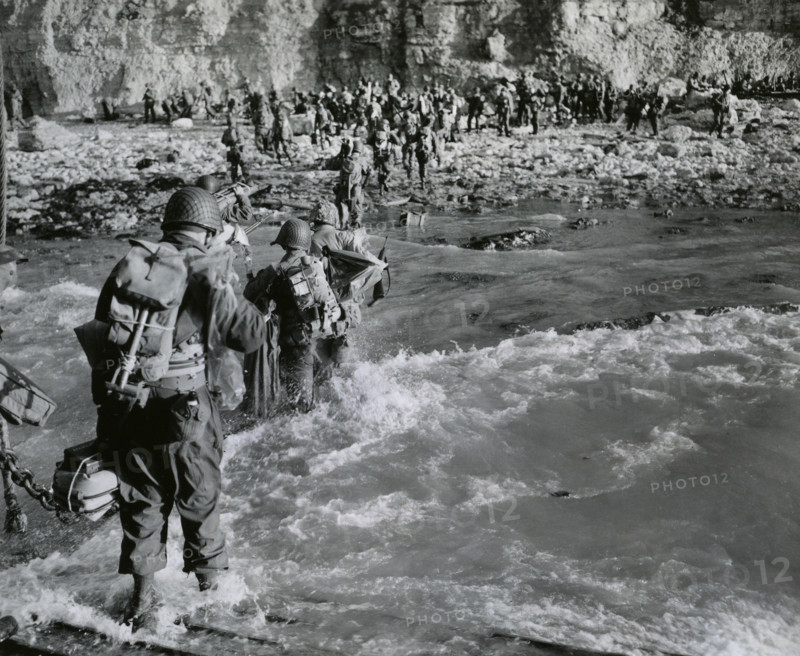 American troops wading through surf before joining additional troops on beachhead, Normandy, France, U.S. Army Signal Corps, June 12, 1944