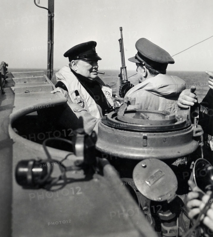 Prime Minister Winston Churchill of Great Britain, left, chatting with British General Sir Alan Brooke, right, Chief of the Imperial General Staff on warship carrying them to British General Sir Bernard Montgomery's temporary headquarters in France, U.S. Army Signal Corps, June 12, 1944