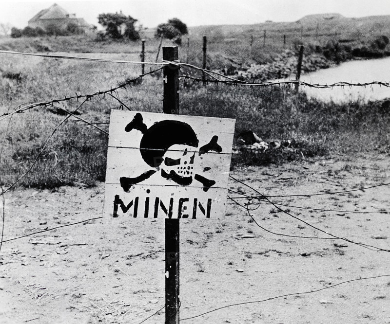 Abandoned German minefield surrounded by barbed wire discovered by advancing U.S. Army troops, Normandy, France, U.S. Army Signal Corps, June 11, 1944