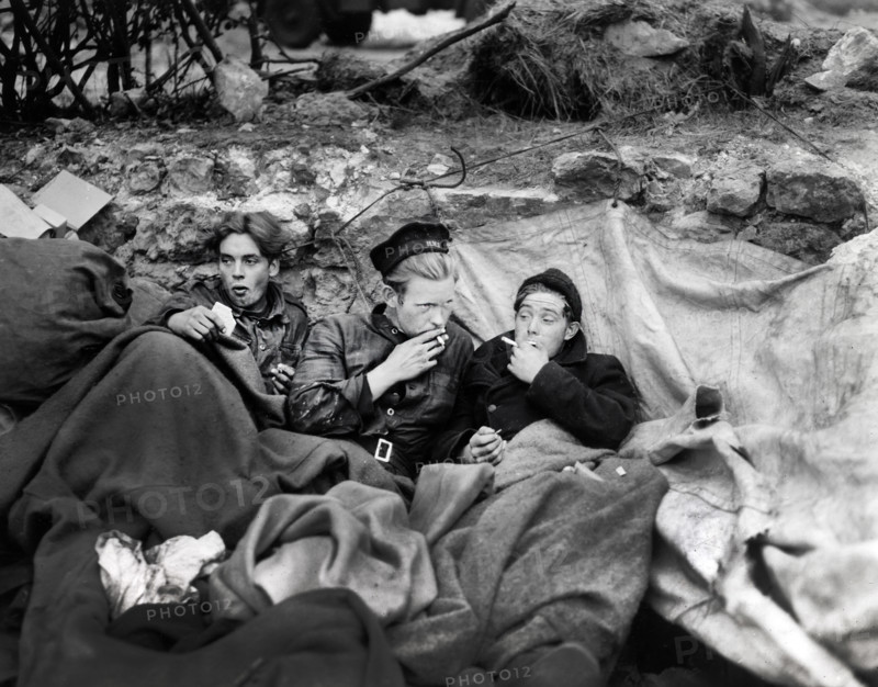 British crew members of an LST having their first night of decent rest after having been brought to shore in smaller landing craft, Omaha Beach, Normandy, France, U.S. Army Signal Corps, June 21, 1944