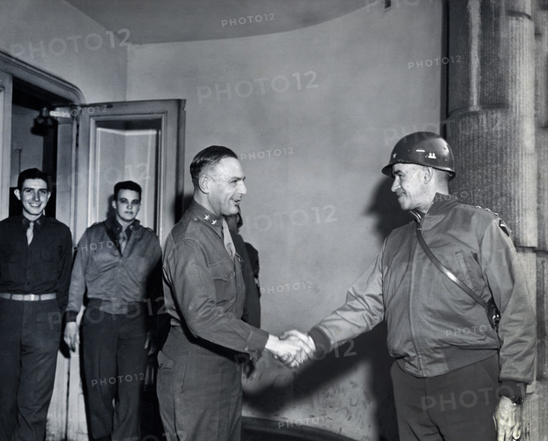 U.S. Lieutenant General Omar N. Bradley (right), 12th Army Group, shaking hands with U.S. Major General Robert W. Hasbrouck, 7th Armored Division, during General Bradley's tour of U.S. First Army Divisions, Eupen, Belgium, Cutler, U.S. Army Signal Corps, February 19, 1945