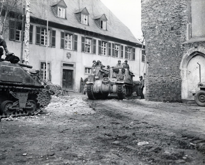 Tank of U.S. 9th Armored Division, U.S. First Army, rolling through street of Limburg, Hesse, Germany, MacDonald, U.S. Army Signal Corps, March 29, 1945