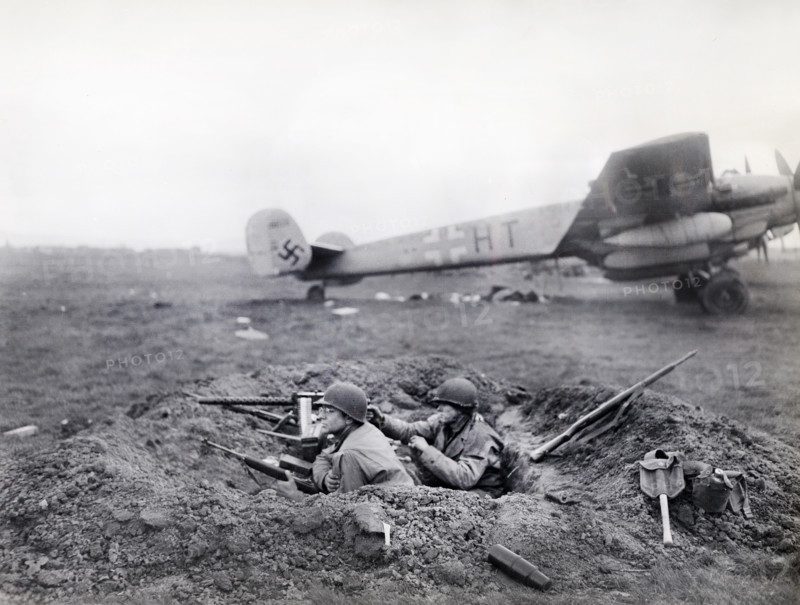U.S. G.I.'s watching for enemy activity from their outpost at German airfield captured by U.S. Ninth Armored Division, U.S. First Army, Fritzlar, Hesse, Germany, U.S. Army Signal Corps, April 1, 1945