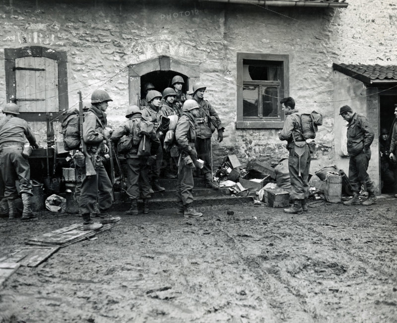 U.S. infantrymen of 16th regiment, 1st Division, U.S. First Army, making final preparations and getting briefed before crossing Roer River, Schneidhausen, North Rhine-Westphalia, Germany, U.S. Army Signal Corps, February 25, 1945