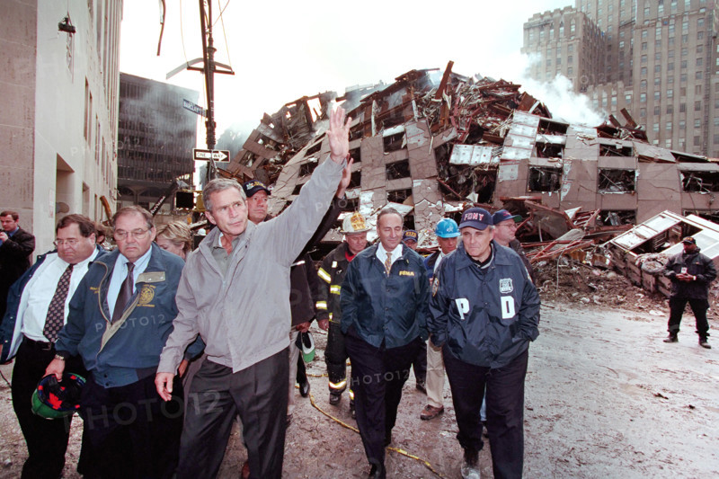 U.S. President George W. Bush waving while touring 7 World Trade Center disaster site with (from left) New York Congressman Jerrold Nadler, Director of New York City’s Office of Emergency Management Richard J. Sheirer, U.S. from New York Senator Hillary Rodham Clinton, New York Governor George Pataki, New York Fire Department Commissioner Thomas Von Essen, U.S. Senator from New York Chuck Schumer, New York City Mayor Rudolph Giuliani and Chief of Staff Joe Hagin, Financial District, Manhattan, New York City, New York, USA, Paul Morse, George W. Bush White House Photo Office, September 14, 2001