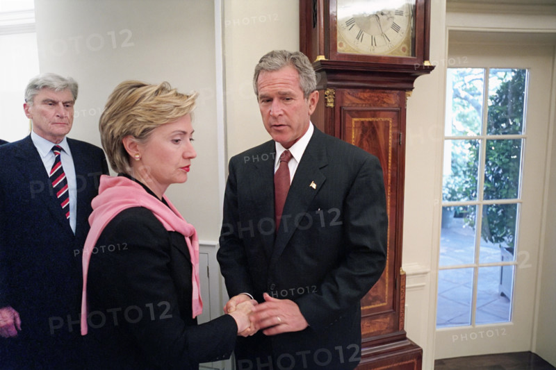 U.S. President George W. Bush shaking hands with U.S. Senator from New York Hillary Rodham Clinton as U.S. Senator from Virginia John Warner looks on, White House Oval Office, Washington D.C., USA, Eric Draper, George W. Bush White House Photo Office, September 13, 2001