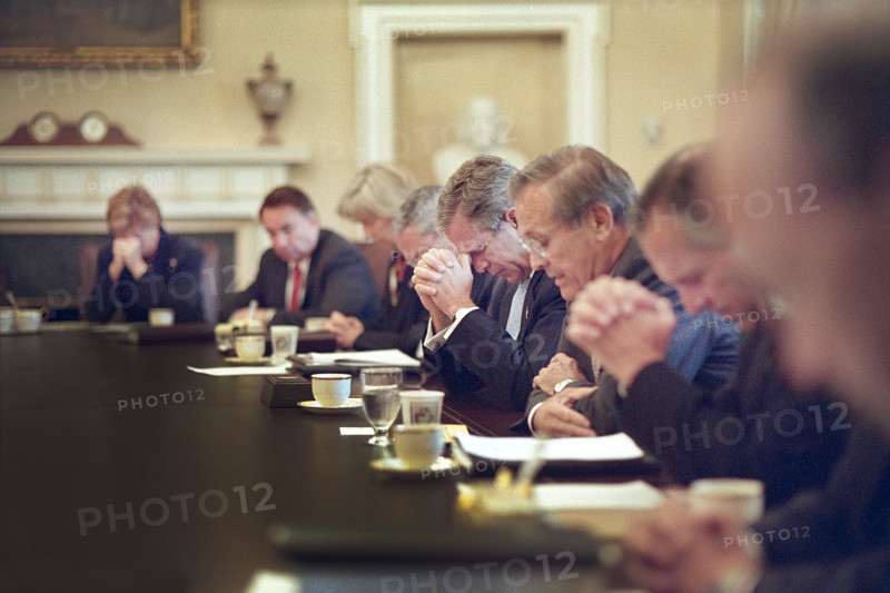U.S. President George W. Bush bowing his head as U.S. Secretary of Defense Donald Rumsfeld leads prayer before cabinet meeting, White House Cabinet Room, Washington, D.C., USA, Eric Draper, George W. Bush White House Photo Office, September 14, 2001