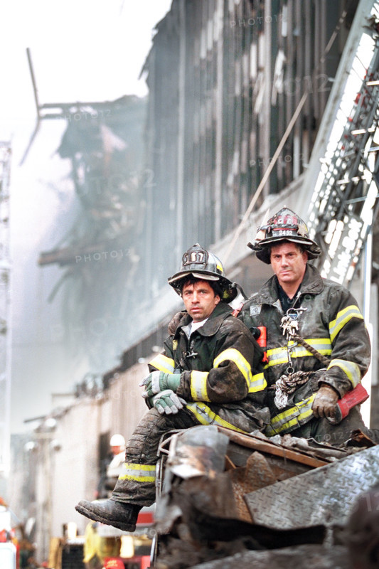 Two firefighters look on during U.S. President George W. Bush's visit to World Trade Center disaster site, Financial District, Manhattan, New York City, New York, USA, Paul Morse, George W. Bush White House Photo Office, September 14, 2001