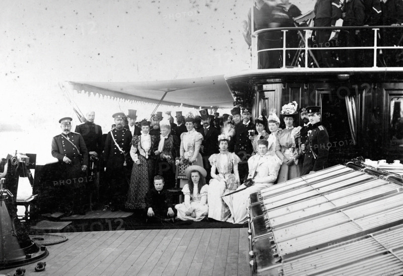 On the deck of the  royal yacht, around King Christian IX and Queen Louise of Denmark, the  royal families of Denmark, Russia, France, Princess Marie of Orléans, and England