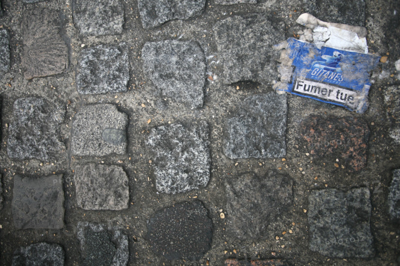 France, Paris 14e, trottoir, boulevard du Montparnasse, pollution, tabac, paquet de cigarette ecrase, paves, tabagisme,