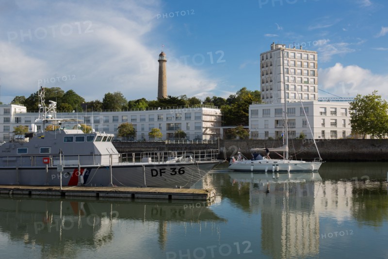 Lorient, port, grey customs boat and sailing boat leaving the port