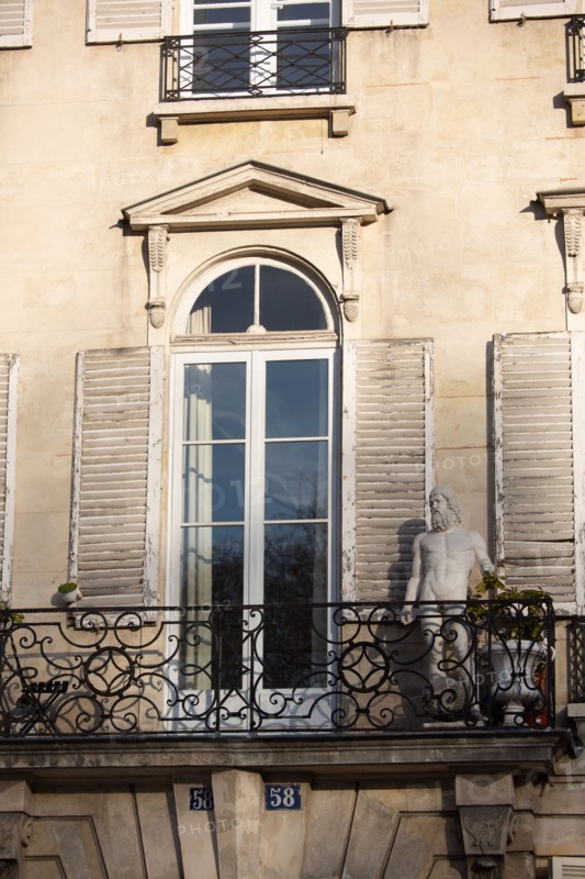 Paris, sculpture on the balcony of a building
