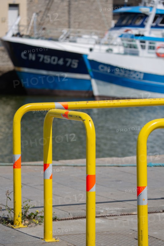 Port en Bessin Huppain, quay with yellow barriers and moored trawlers