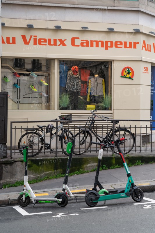 Paris, bicycles and scooters in front of Le Vieux Campeur shop