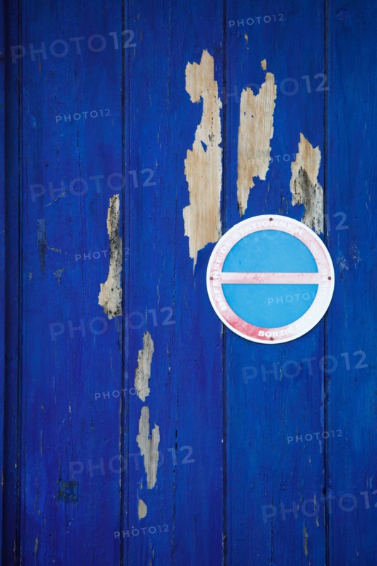 Blue door and no-parking sign