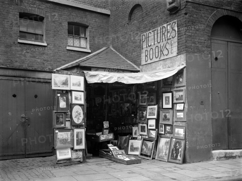 Framed pictures displayed outside a second hand book and picture shop, London, 1933
