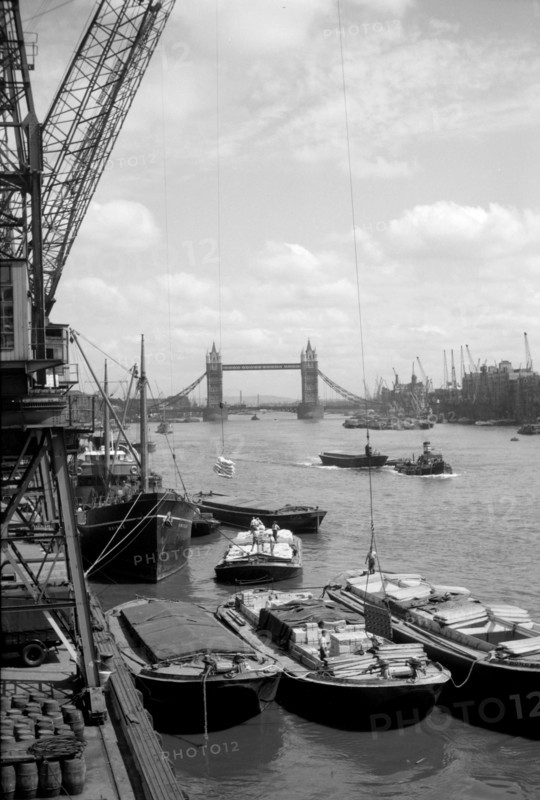 Tower Bridge with shipping in the Pool of London and vessels at Hay's Wharf, Southwark, c1945-c1965