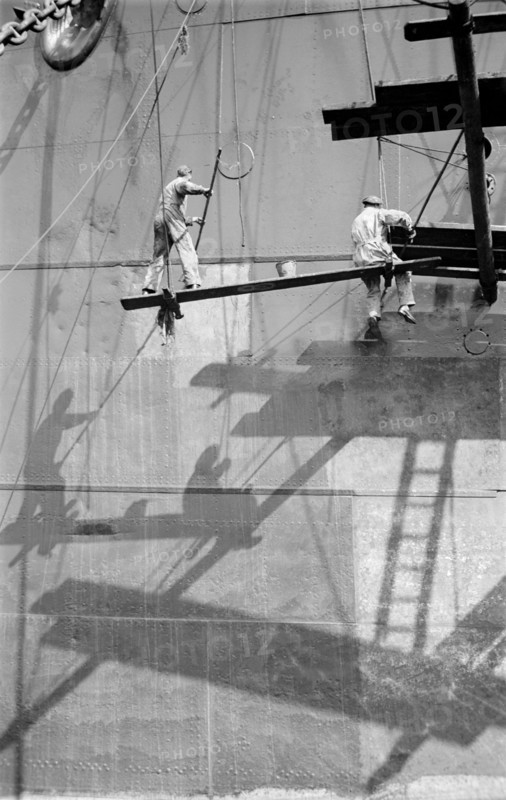 Two men painting a ship in the Royal Albert Dock, Canning Town, London, c1945-c1965