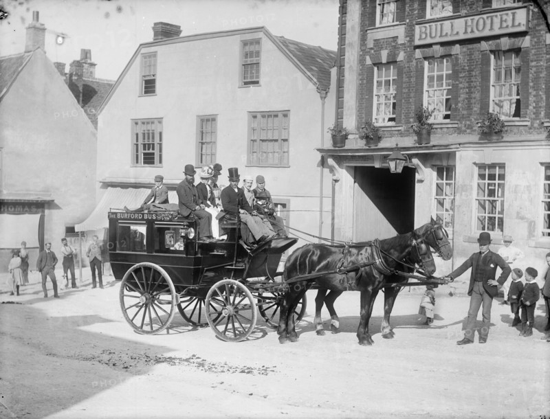 Horse drawn bus with passengers outside the Bull Hotel, Burford High Street, Oxon, c1860-c1922