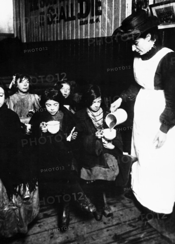 Slum sister giving out farthing breakfast, London. Artist: Unknown
