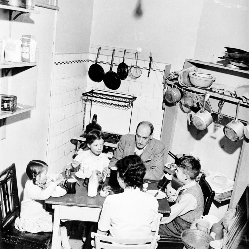 A family dining in their London home, c1950s. Artist: Henry Grant