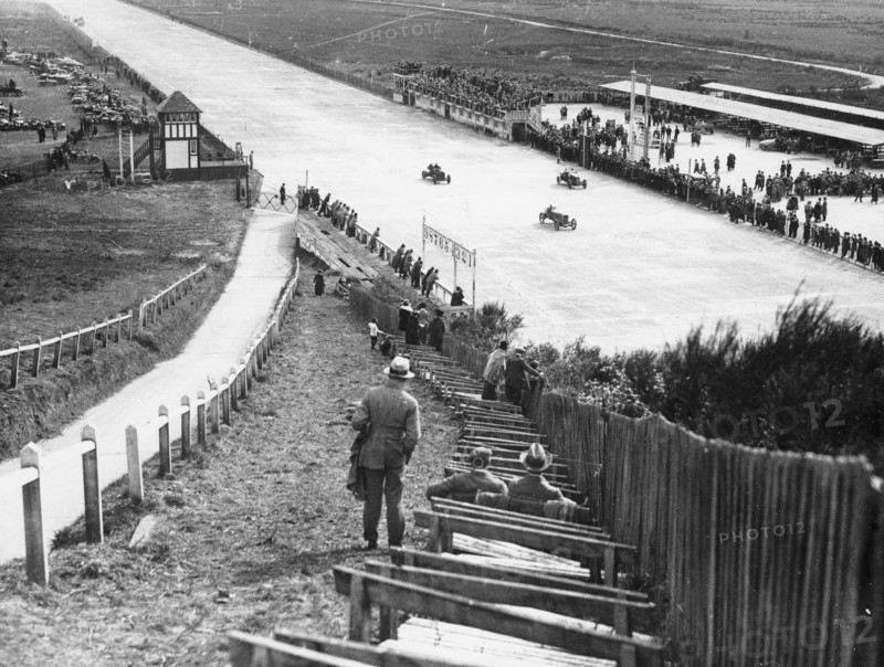 Spectators watching motor racing from the Test Hill, Brooklands, Surrey, (1920s?). Artist: Unknown
