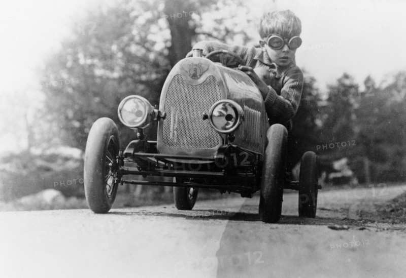 Boy in a pedal car. Artist: Unknown