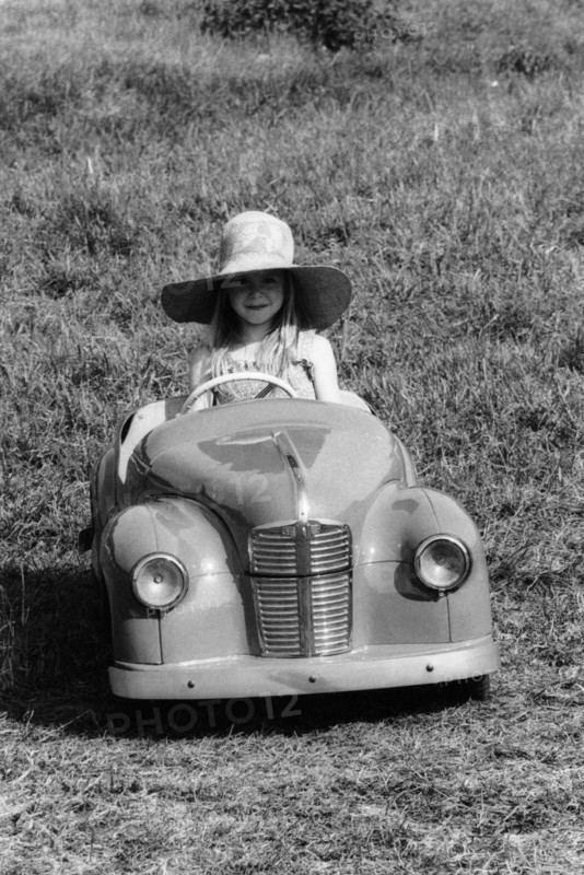 Girl in a 1948 vintage Austin J40 pedal car. Artist: Unknown
