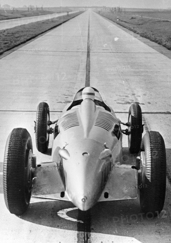 Bernd Rosemeyer in Auto Union record-breaking car, 1937. Artist: Unknown