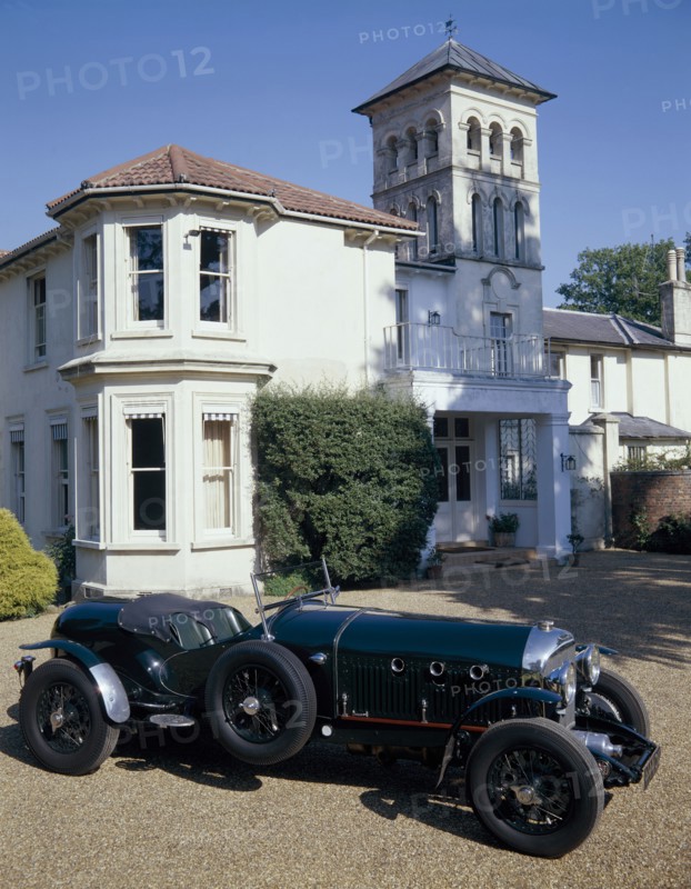 A 1930 Bentley Supercharged outside a house. Artist: Unknown
