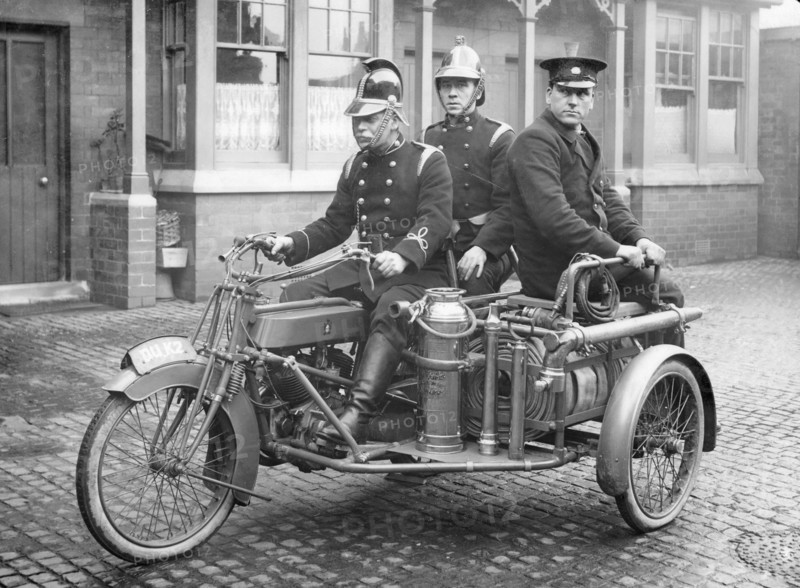A Rex motorcycle being used by firemen. Artist: Unknown