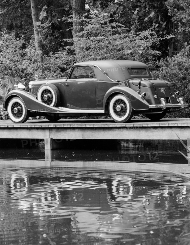 A 1933 Hispano-Suiza K6 reflected in a lake. Artist: Unknown