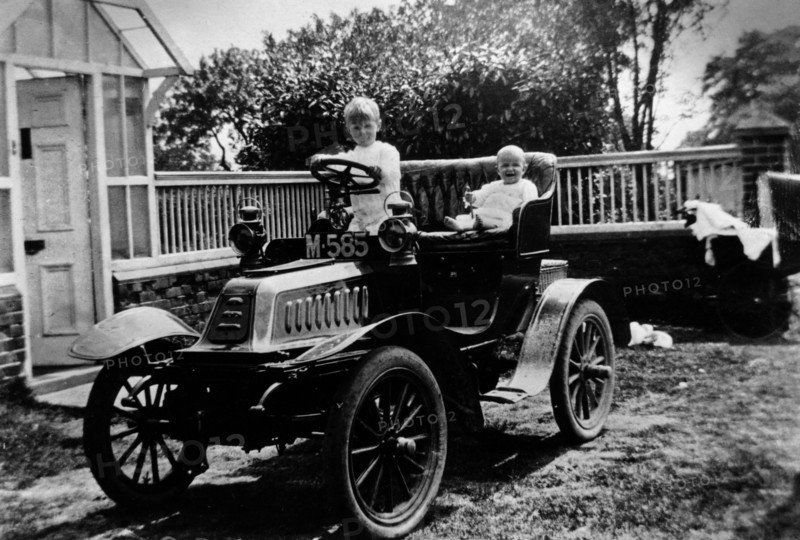 A child at the wheel of a De Dion Bouton car, 1903. Artist: Unknown