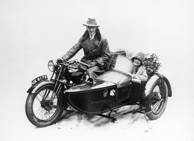 Man riding an AJS motorbike with a woman in the sidecar, 1939. Artist: Unknown