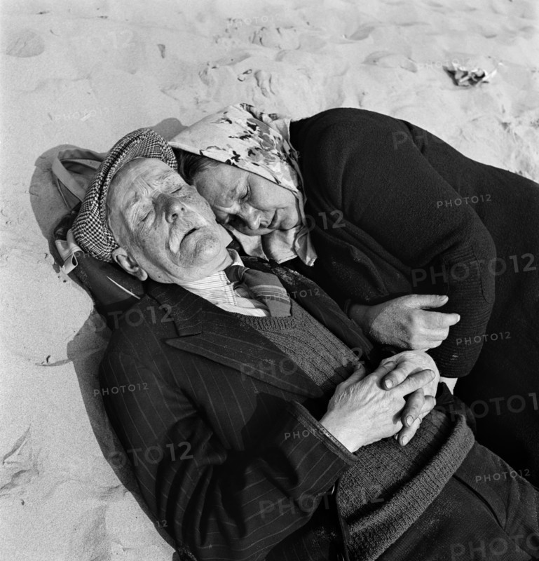 An elderly couple doze on the beach, Blackpool, c1946-c1955