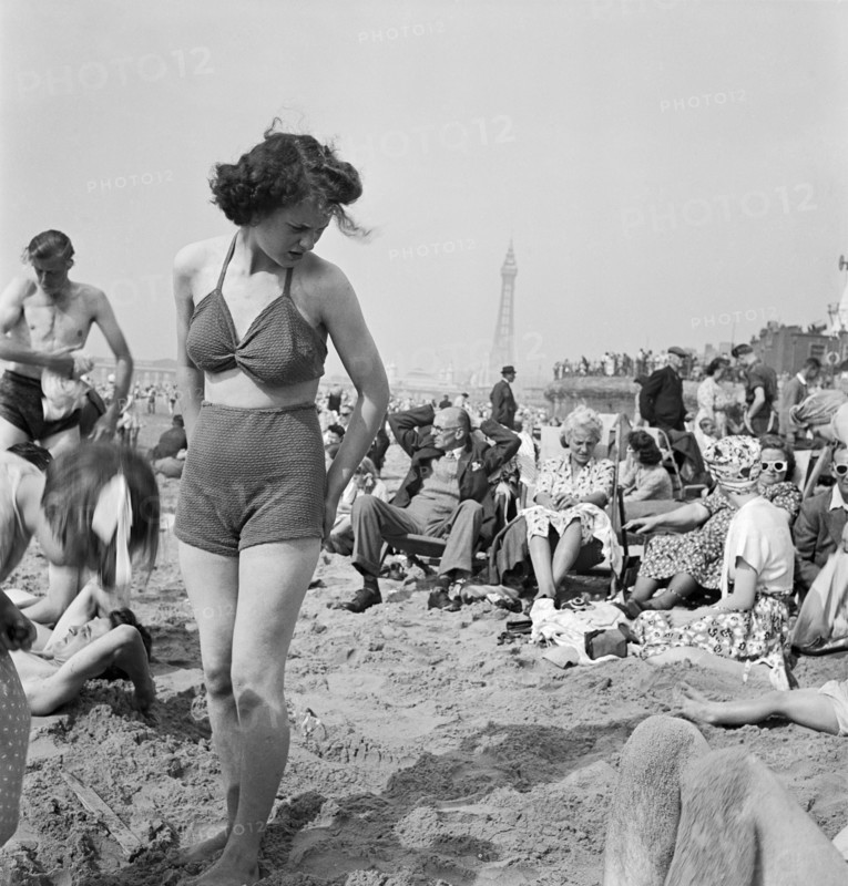 A young woman in a knitted bathing costume on the beach, Blackpool, c1946-1955