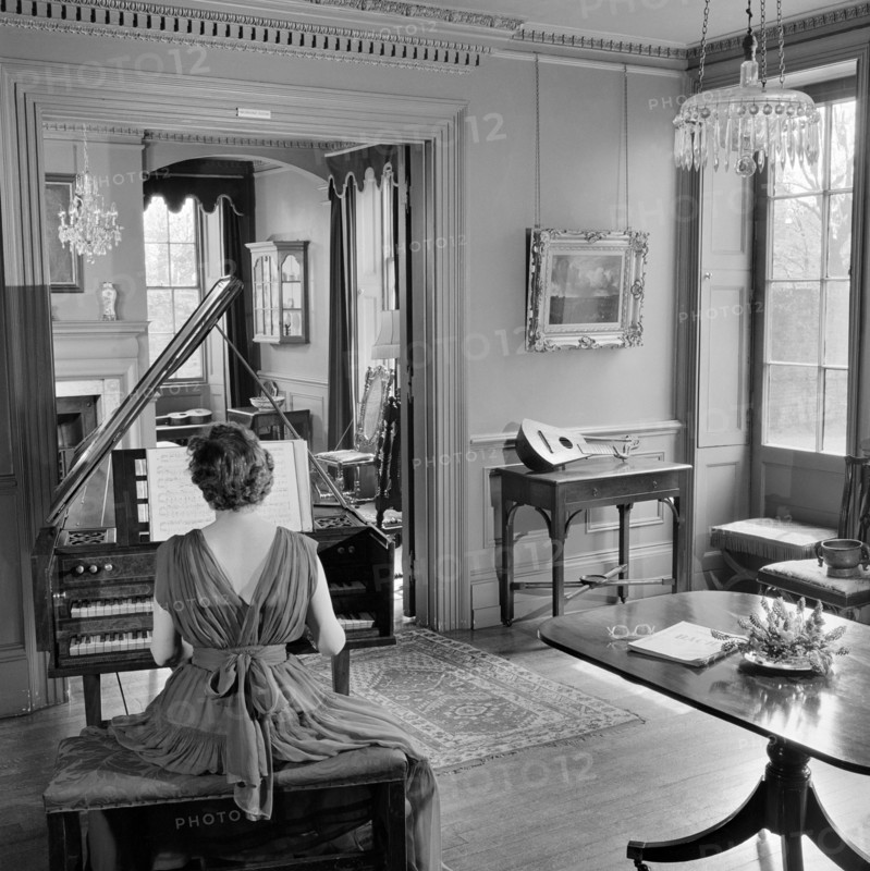 Woman in evening dress playing the harpsichord, Fenton House, London, 1960-1965