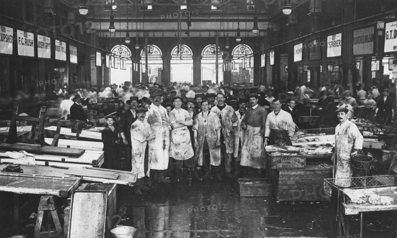 The interior of Billingsgate Market showing fishmongers and their stalls, London, c1918. Artist: Unknown