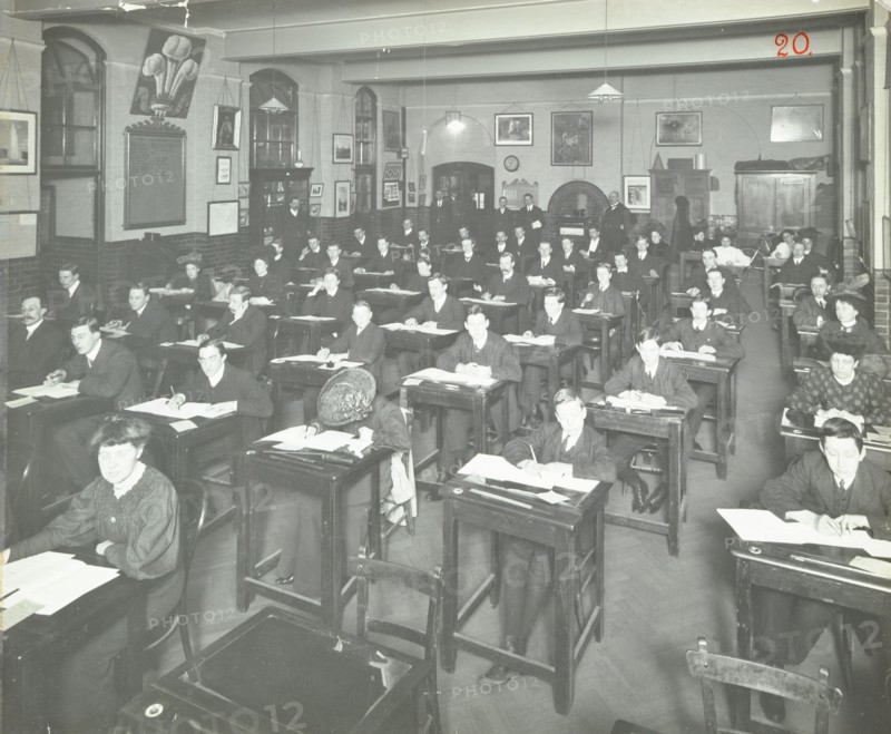 Examination class for male and female students, Queen's Road Evening Institute, London, 1908. Artist: Unknown.