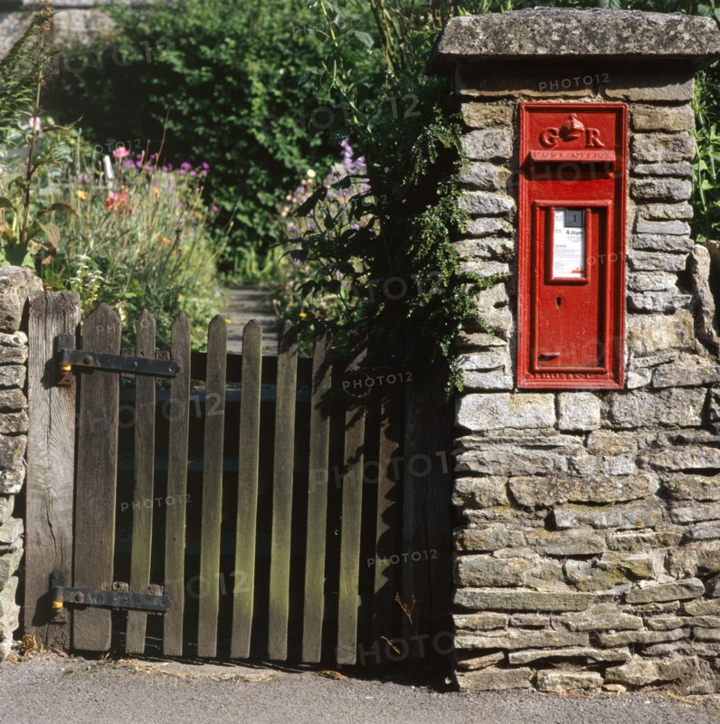 Wall-mounted post box and wooden gate, Upper Slaughter, Cotswolds, Gloucestershire