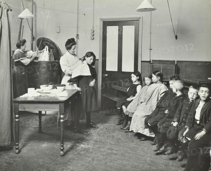 Nurse cutting children's verminous hair, Finch Street Cleansing Station, London, 1911. Artist: Unknown.